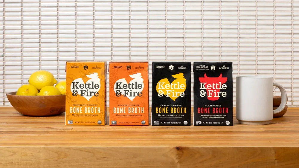 A row of Kettle & Fire cartons with lemons on a kitchen counter