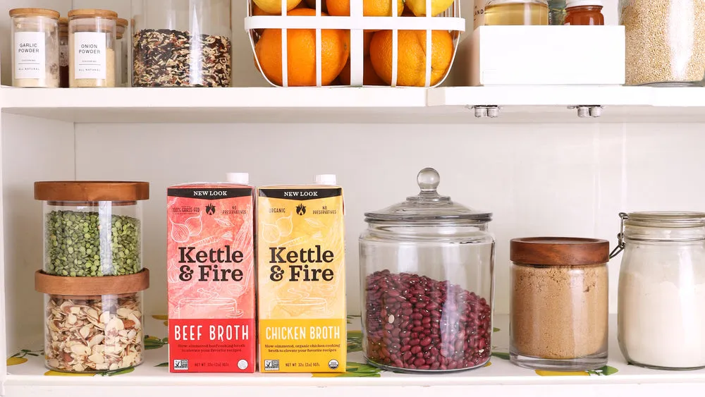 Kettle & Fire beef and chicken cooking broth cartons on a pantry shelf among glass jars